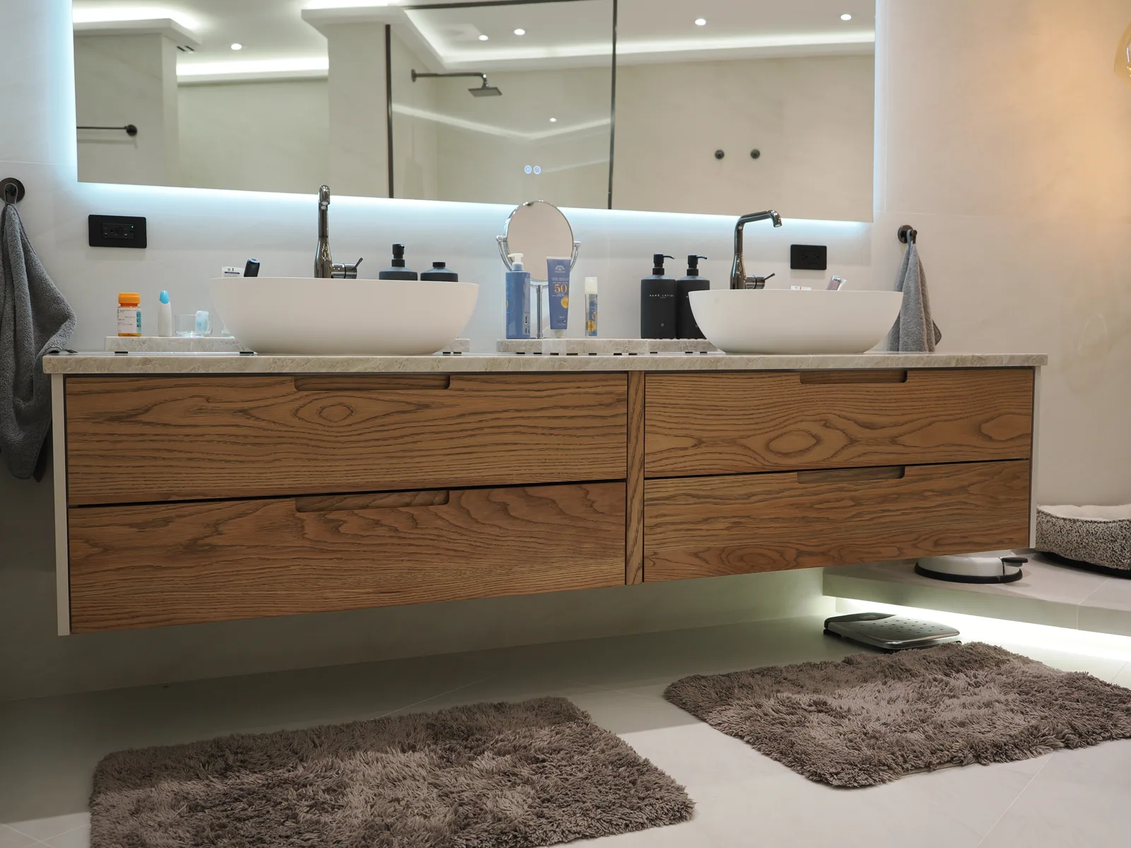 Floating wood vanities completed by LeVika Furniture